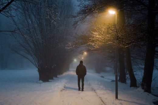 Man walking in winter snow