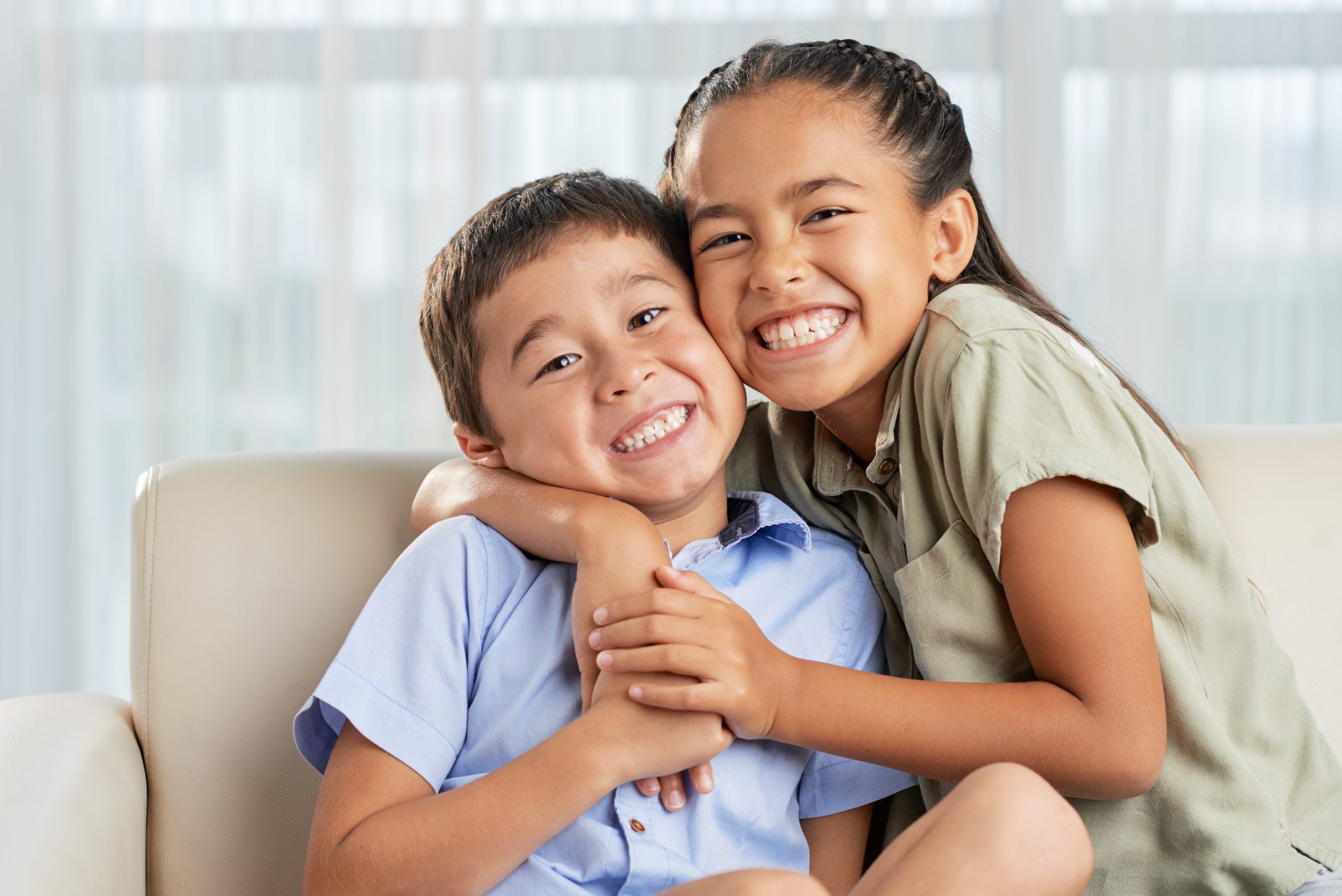Girl hugging brother
